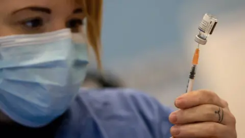 Getty Images Medic with vaccine