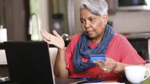 Getty Images A stock image of an older woman at a computer