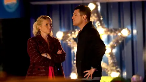 Wales News Service Matthew Horne and Joanna Page film in front of a giant illuminated Christmas star