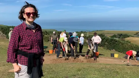 BBC Rachael Crellin in front of part of the excavations