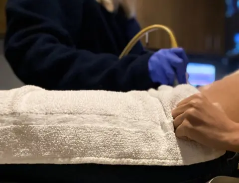 Getty Images Woman receiving abdominal ultrasound
