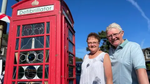 Alan and Kate Richmond by the old phone box in Crich