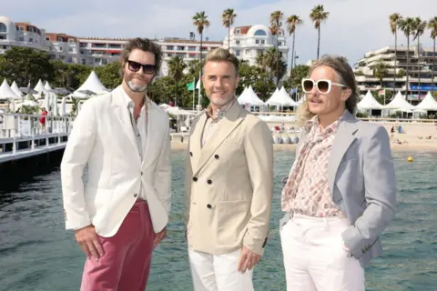 Getty Images Take That (Jason Orange, Gary Barlow and Mark Owen) promoting their new film in Cannes