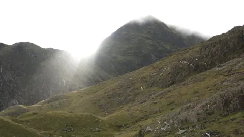 PA | Nick Potts Snowdon under cloud as the sun tries to push through