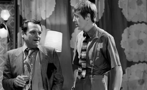 Black and white image of David Jason and Nicholas Lyndhurst standing side by side during filming