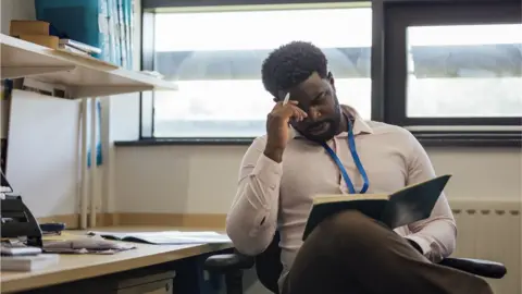 Getty Images teacher marking student's work