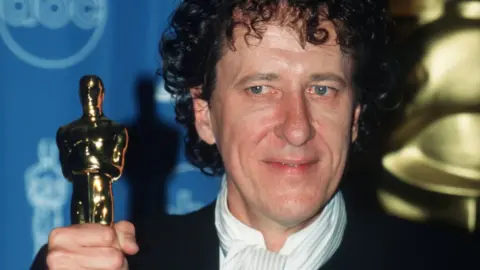 Getty Images Geoffrey Rush with his Oscar in 1997