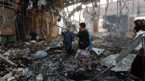 AFP Yemeni rescue workers search for victims amid the rubble of a destroyed building following reported airstrikes by Saudi-led coalition air-planes on the capital Sanaa on October 8, 201