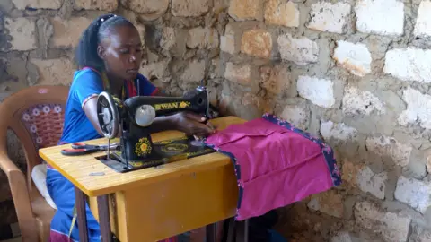 Immaculate Wiziri working at a sewing machine in Malindi, Kenya