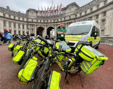 Ryan Young Ryan Young standing alongside St John Ambulance vehicles in London during his deployment for the Queen's Platinum Jubilee