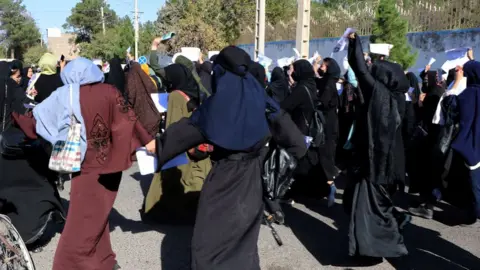 Getty Images Women protest in Afghanistan demanding education