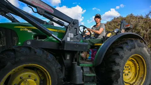 Getty Images Aida drives a tractor in her village of Covas do Barroso