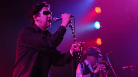 Getty Images Shane MacGowan singing on stage