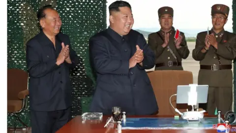 KCNA via REUTERS North Korean leader Kim Jong-un applauds as he observes missile test, 24 August 2019