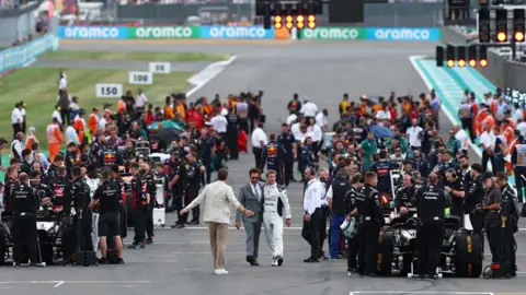 Reuters Actors Brad Pitt, Javier Bardem and Tobias Menzies are pictured at the British Grand Prix