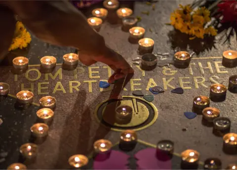 Getty Images A man touches the Tom Petty and the Heartbreakers star on The Hollywood Walk of Fame after Petty suffered a massive heart attack last night that left him in very grave condition, on October 2, 2017