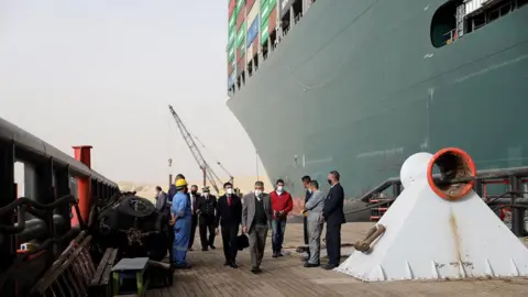 Suez Canal Authority Egyptian officials inspect the operation to refloat the Ever Given ship