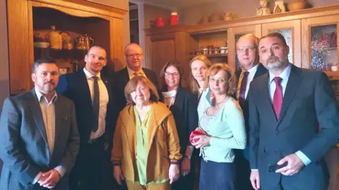 Twitter / @AnnLinde Svetlana Alexievich (centre) surrounded by diplomats at her home in Minsk, Belarus. Photo: September 2020