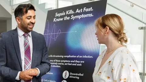 PA Media Aimee King with health secretary, Humza Yousaf at the Roslin Institute