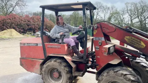 Sophie Lenaerts driving an agricultural vehicle on her farm