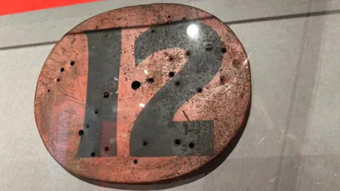 The number plate 12 from the winning motorcycle in the 1934 senior race