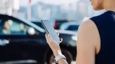 Woman looks at mobile phone