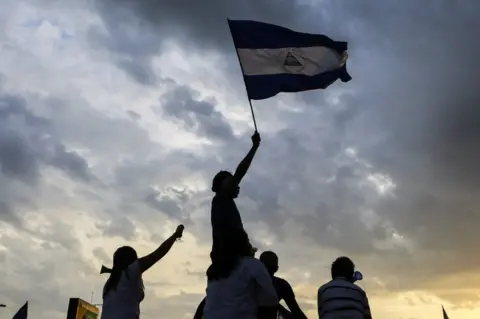 DIANA ULLOA / AFP Students fly a Nicaraguan national flag as they take part in a protest against the government of Nicaraguan President Daniel Ortega in Managua on 15 May 2018.