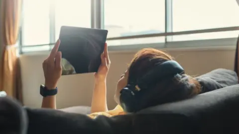 Getty Images A woman watching a tablet device