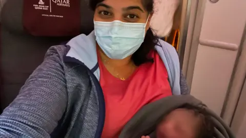 Dr Aisha Khatib holding Miracle Aisha