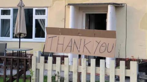 A thank you sign in front of a house