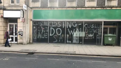 Man walking near closed shop in Peterborough