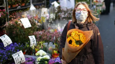 Getty Images Woman holding flowers