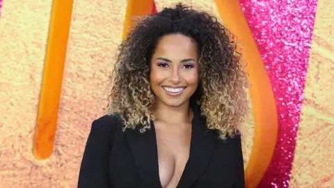 Getty Images Amber smiles on a red carpet