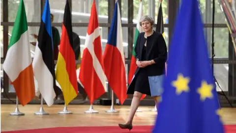 Getty Images Theresa May arrives at Brussels summit