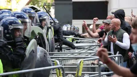 PA Media Police are confronted by protesters in Whitehall near Parliament Square