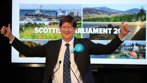 PA Scottish Conservative candidate Alexander Burnett has both his thumbs up, celebrating his win in Aberdeenshire West