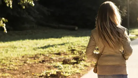 Getty Images woman walking in woods