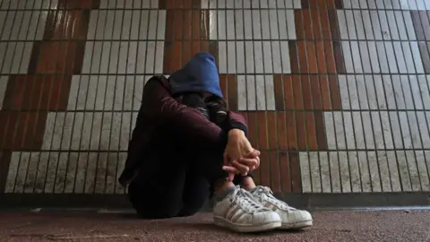 PA Media A teenage girl sitting down