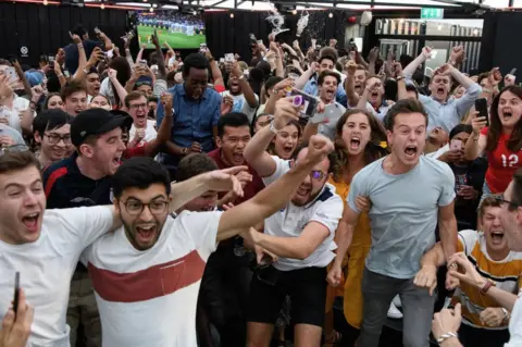 Getty Images Fans celebrate England victory at Boxpark, London