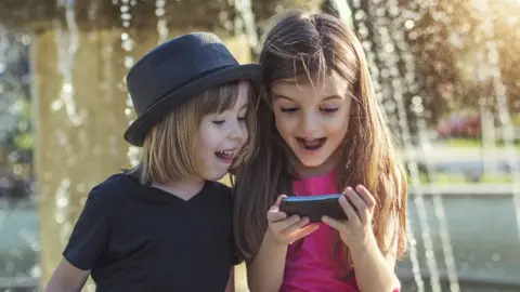 Getty Images Children on a phone