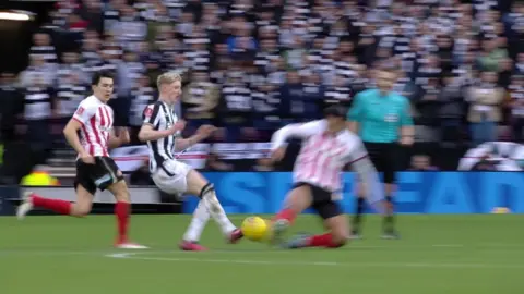 Jobe Bellingham tackles Anthony Gordon in Sunderland's FA Cup tie against Newcastle