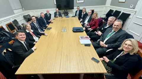 Lyndon Farnham Council of Ministers of Jersey sitting around a meeting table