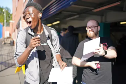 Jacob King / PA Media A student celebrates after opening his GCSE results