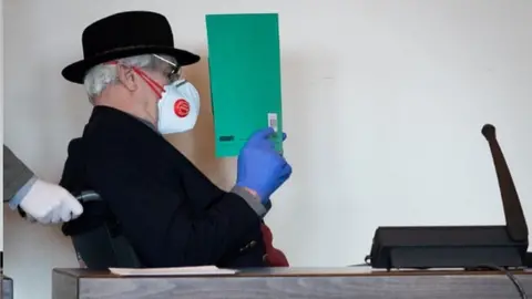 AFP Bruno Dey sat in a wheelchair in court, 14 Apr 20