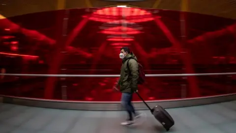 EPA A traveller at Adolfo Suarez Barajas airport in Madrid