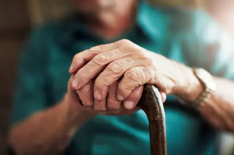 Getty Images Old man with walking stick