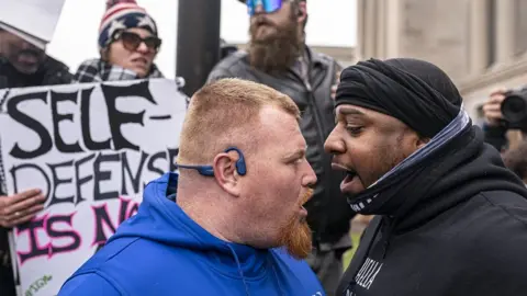 Two men argue outside court