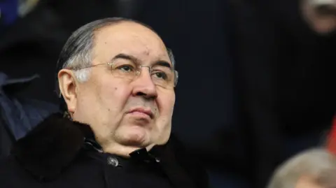 Getty Images Alisher Usmanov watching an Arsenal game