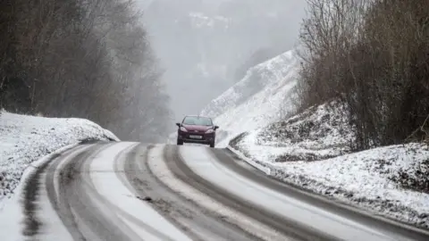 Getty Images Car on snowy road