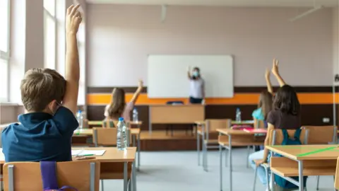 Getty Images pupils in class covid teacher in mask